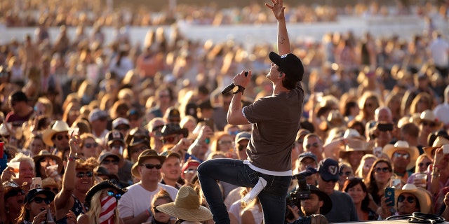 Granger Smith performing on stage in front of a crowd