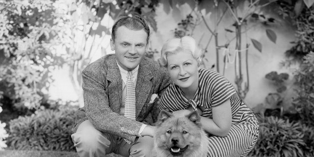 James Cagney posing for a photo with his wife and their dog