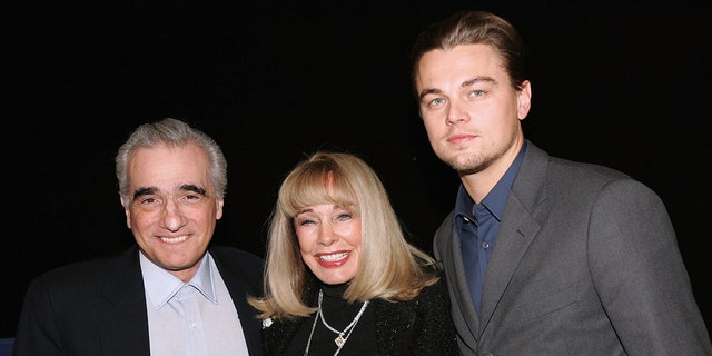 Martin Scorsese, Terry Moore and Leonardo DiCaprio posing in front of a camera
