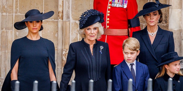 Meghan Markle wearing black next to Camilla and Kate Middleton and her children all wearing black