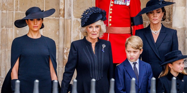 Meghan Markle wearing black next to Camilla and Kate Middleton and her children all wearing black