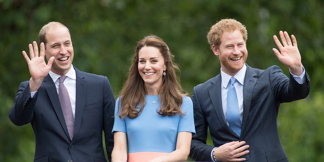Prince William, Kate Middleton and Prince Harry all smiles wearing various shades of blue