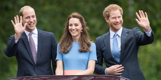 Prince William, Kate Middleton and Prince Harry all smiles wearing various shades of blue