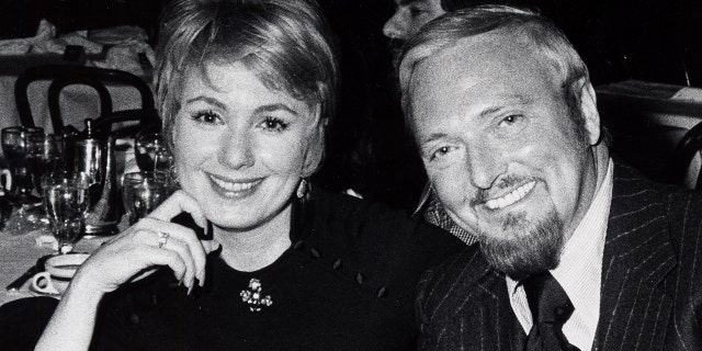 Shirley Jones and Jack Cassidy leaning against each other and smiling