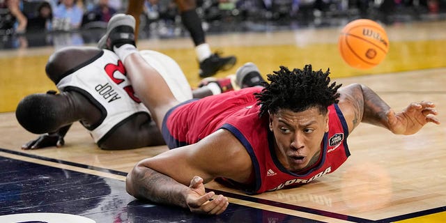 Florida Atlantic forward Giancarlo Rosado, right, falls over San Diego State forward Aguek Arop during the first half of a Final Four game in the NCAA Tournament Saturday, April 1, 2023, in Houston. 