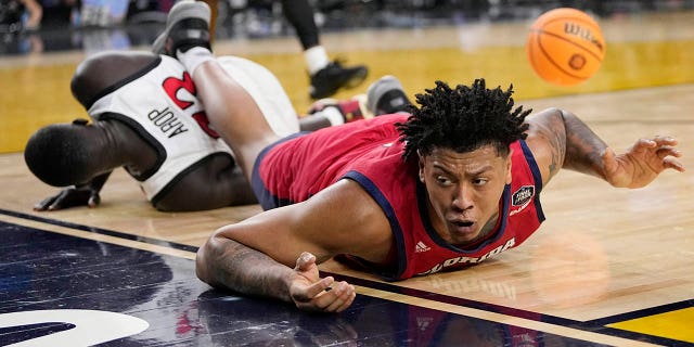 Florida Atlantic forward Giancarlo Rosado, right, falls on San Diego State forward Aguek Arop during the first half of a Final Four game in the NCAA Tournament on Saturday, April 1, 2023, in Houston . 