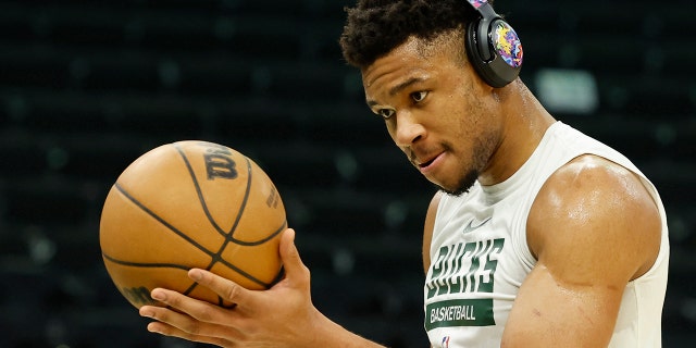 Giannis Antetokounmpo warms up