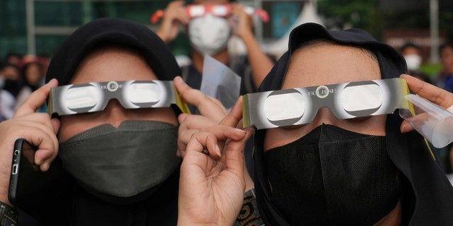 Indonesian women use protective glasses