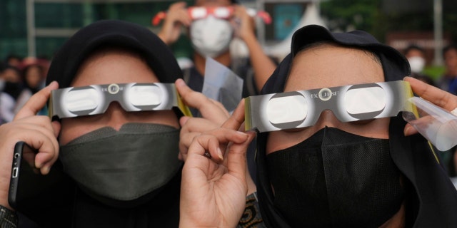 Indonesian women use protective glasses