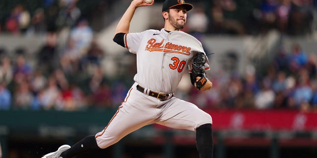 Grayson Rodriguez #30 of the Baltimore Orioles throws a pitch during his Major League debut against the Texas Rangers at Globe Life Field on April 5, 2023 in Arlington, Texas.