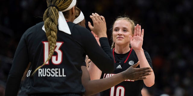 Louisville guard Hailey Van Lith is congratulated by teammates during the Elite 8 game against Iowa in the NCAA Tournament, March 26, 2023, in Seattle.