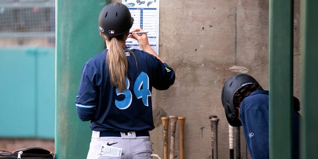 Ronnie Gajownik of the Hillsboro Hops writes on the lineup card in the dugout during a game against the Tri-City Dust Devils at Gesa Stadium Thursday, April 6, 2023, in Paseco, Wash.