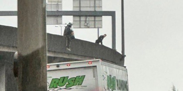 Homeless woman dangling from bridge