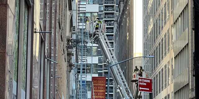 Firefighters inspect the site of a garage collapse at 37 Ann Street in New York City, Tuesday, April 18, 2023.