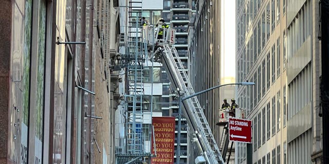 Firefighters inspect the site of a garage collapse at 37 Ann Street in New York City, Tuesday, April 18, 2023.