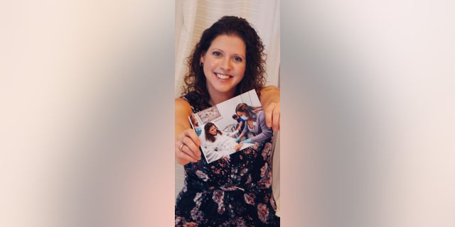 Davis, pictured with a photo of herself receiving the vaccine, said the shot has given her peace of mind and reduced her worries about her breast cancer coming back. 