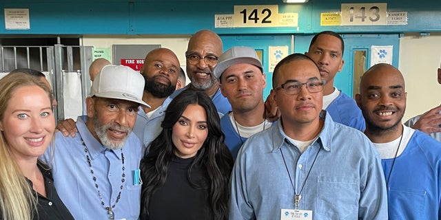 Kim Kardashian, center, poses with several of the inmates her group met with in a Lancaster, California, prison Monday.