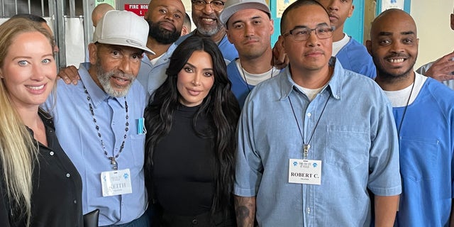 Kim Kardashian, center, poses with several of the inmates her group met with in a Lancaster, California, prison Monday.