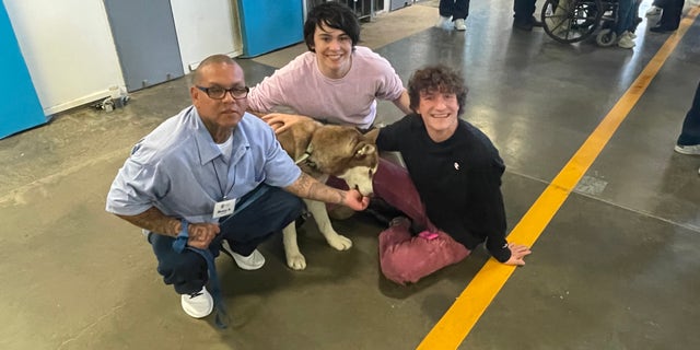 The group met with members of the prison's PAWS For Life program as part of the tour.