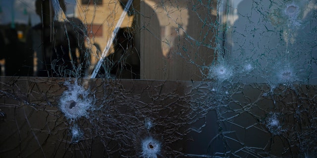 A man inspects damage to a shopping center from an intercepted rocket fired from Lebanon in Shlomi, northern Israel Thursday, April 6, 2023. Israeli air defenses intercepted a rocket fired from Lebanon into northern Israel, the Israeli military said. It was not immediately clear who was behind the rare rocket fire from Lebanon.