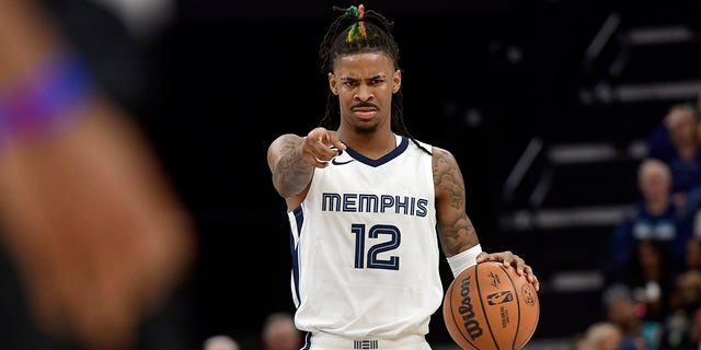 Memphis Grizzlies guard Ja Morant, #12, handles the ball in the second half of an NBA basketball game against the Portland Trail Blazers Tuesday, April 4, 2023, in Memphis, Tennessee.
