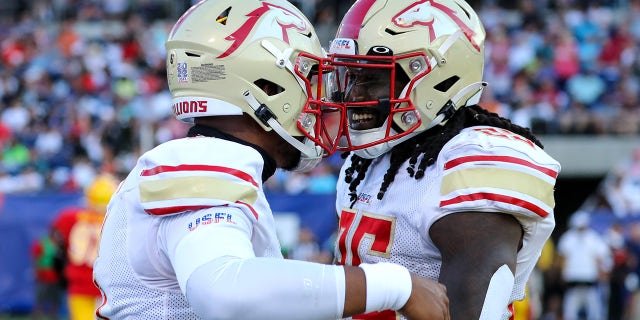 Birmingham Stallions quarterback J'Mar Smith (6) and Birmingham Stallions running back Bo Scarbrough (25) celebrates after Scarbrough scored on a 36-yard run during the first quarter of the USFL Championship Game between the Birmingham Stallions and Philadelphia Stars on July 3, 2022, at the Tom Benson Hall of Fame Stadium in Canton, OH.