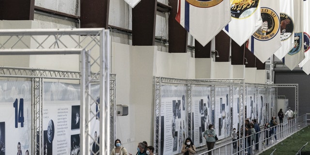 Visitors tour the Saturn V rocket exhibit at the NASA Johnson Space Center 