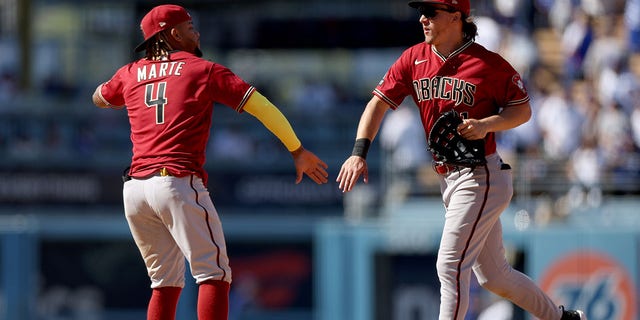 Jake McCarthy #31 and Ketel Marte #4 of the Arizona Diamondbacks celebrate a 2-1 win over the Los Angeles Dodgers at Dodger Stadium on April 2, 2023 in Los Angeles, California.