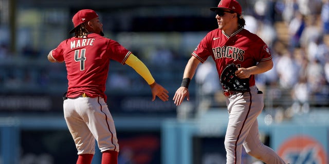 Jake McCarthy #31 and Ketel Marte #4 of the Arizona Diamondbacks celebrate a 2-1 win over the Los Angeles Dodgers at Dodger Stadium on April 02, 2023 in Los Angeles, California.