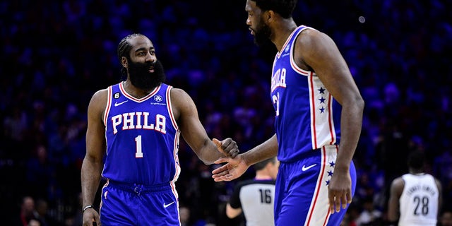 Philadelphia 76ers' James Harden, left, slaps hands with Joel Embiid in the first half during Game 2 in the first round of the NBA basketball playoffs against the Brooklyn Nets, Monday, April 17, 2023, in Philadelphia. 