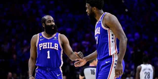 Philadelphia 76ers' James Harden, left, slaps hands with Joel Embiid in the first half during Game 2 in the first round of the NBA basketball playoffs against the Brooklyn Nets, Monday, April 17, 2023, in Philadelphia.
