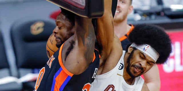 Cleveland Cavaliers center Jarrett Allen, right, fouls New York Knicks forward Julius Randle during the second half of Game 2 of an NBA basketball first-round playoff series, Tuesday, April 18, 2023, in Cleveland.