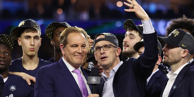 Head coach Dan Hurley of the Connecticut Huskies talks with Jim Nantz after winning the NCAA Men's Basketball Tournament National Championship game on April 3, 2023, in Houston.