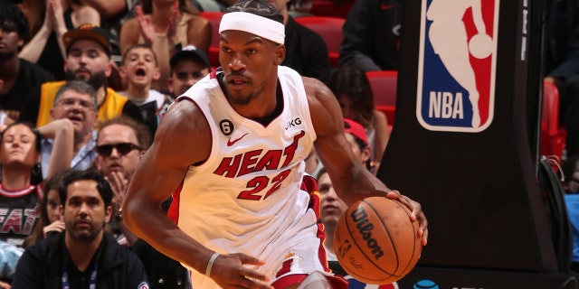 Jimmy Butler #22 of the Miami Heat dribbles the ball during the 2023 Play-In Tournament against the Atlanta Hawks on April 11, 2023, at Kaseya Center in Miami, Florida.