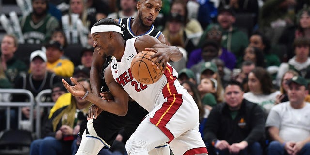 Miami Heat forward Jimmy Butler, #22, drives against Milwaukee Bucks forward Khris Middleton, #22, in the second half during game one of the 2023 NBA Playoffs at Fiserv Forum in Milwaukee April 16, 2023.