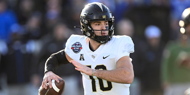 John Rhys Plumlee #10 of the UCF Knights drops back to pass against the Duke Blue Devils in the Military Bowl Presented by Peraton  at Navy-Marine Corps Memorial Stadium on December 28, 2022 in Annapolis, Maryland.