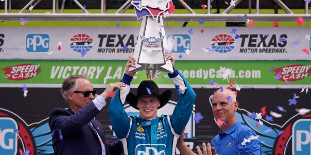 Josef Newgarden, center, celebrates winning the IndyCar race at Texas Motor Speedway in Fort Worth, Texas on Sunday, April 2, 2023.