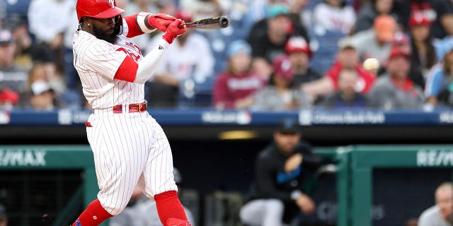 Josh Harrison #2 of the Philadelphia Phillies hits a single during the second inning against the Miami Marlins at Citizens Bank Park on April 11, 2023 in Philadelphia, Pennsylvania.