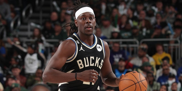 Jeru Holiday #21 of the Milwaukee Bucks dribbles the ball during a game against the Miami Heat during a Round One game of the 2023 NBA Playoffs at Fiserve Forum Center on April 16, 2023 in Milwaukee, Wisconsin. 