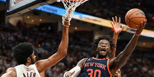 New York Knicks' Julius Randle, #30, shoots against Cleveland Cavaliers' Jarrett Allen, #31, during the second half of Game 1 in a first-round NBA basketball playoffs series Saturday, April 15, 2023, in Cleveland.