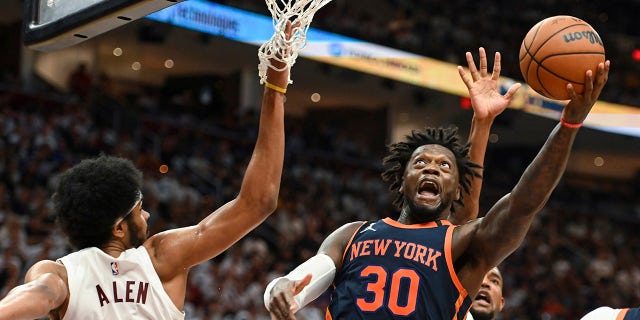 New York Knicks' Julius Randle, #30, shoots against Cleveland Cavaliers' Jarrett Allen, #31, during the second half of Game 1 in a first-round NBA basketball playoffs series Saturday, April 15, 2023, in Cleveland.