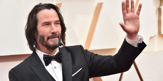 Keanu Reeves waving