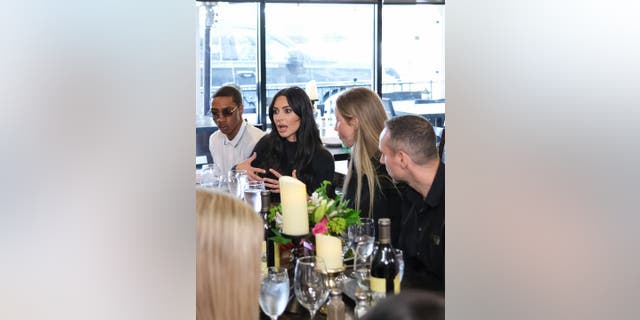 Kim Kardashian speaks to the Future Shapers Advisory Council and members of the REFORM Alliance at La Papillon, a steakhouse and seafood restaurant in Lancaster, California.