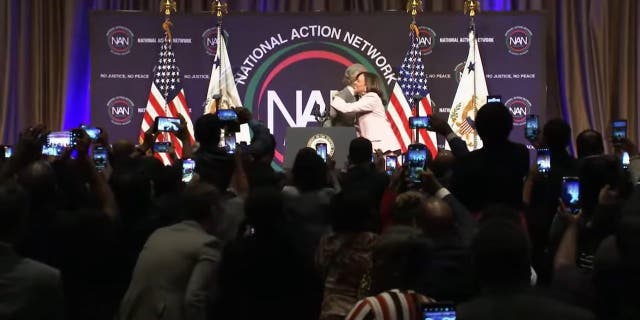 Vice President Kamala Harris embraces Rev. Al Sharpton on the stage of the National Action Network conference.