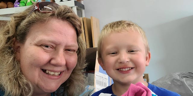 Luke Flerlage, 6, has been volunteering with Karen Melser (pictured left) and Alleluia Baskets for the last three years.