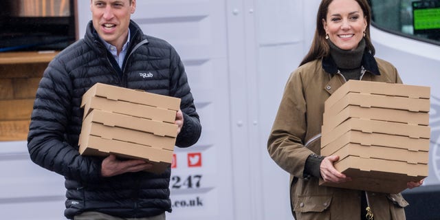 Kate Middleton and Prince William carry pizza
