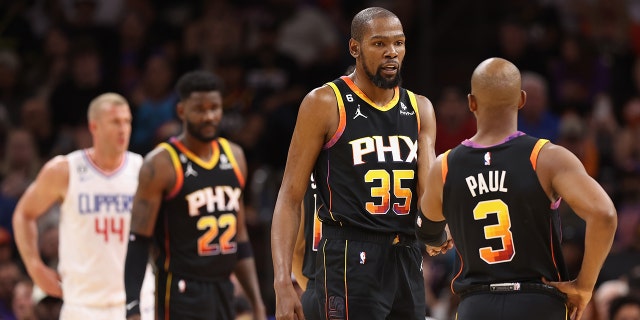 Kevin Durant #35 of the Phoenix Suns talks with Chris Paul #3 during the first half Game One of the Western Conference First Round Playoffs against the LA Clippers at Footprint Center on April 16, 2023 in Phoenix, Arizona.