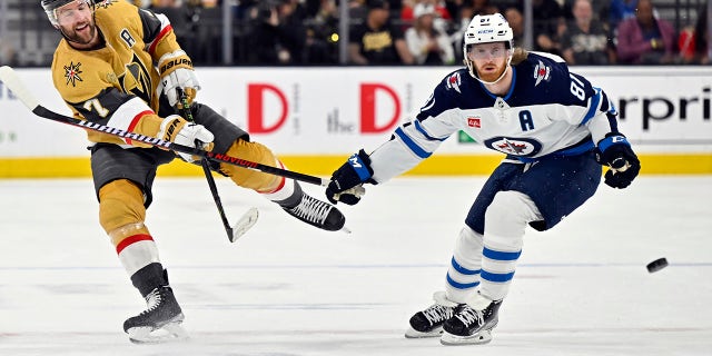 Kyle Conner battles for the puck