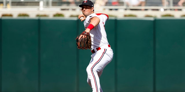 Kyle Farmer of the Minnesota Twins throws to first base to get out Andrew Vaughn of the Chicago White Sox in the eighth inning of a game at Target Field April 10, 2023, in Minneapolis.