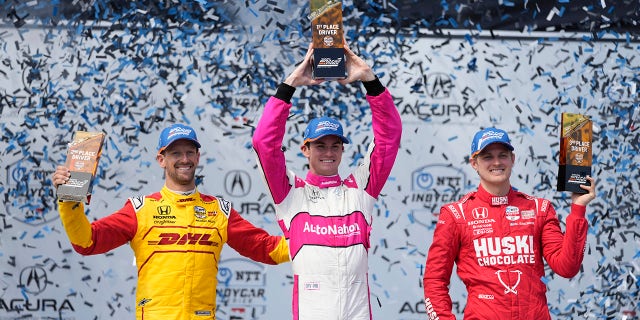 Winner Kyle Kirkwood, center, celebrates with second-place Romain Grosjean, left, of Switzerland, and third-place Marcus Ericsson during the victory ceremony for the IndyCar Grand Prix of Long Beach auto race Sunday, April 16, 2023, in Long Beach, Calif.